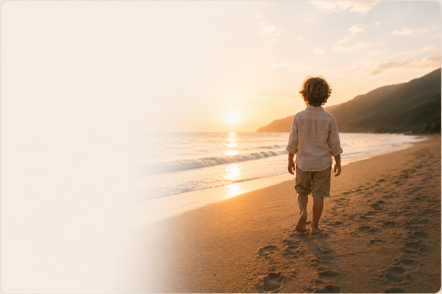 A child standing alone on a quiet beach at sunset